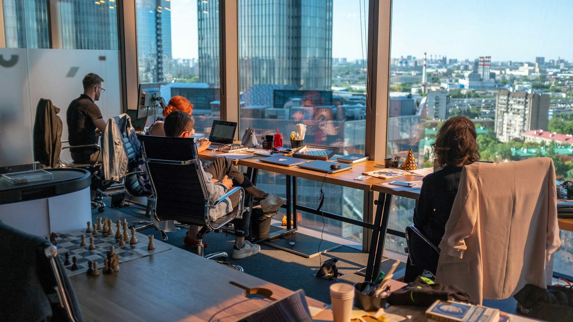 Colleagues working in a bright loft office with a steel staircase
